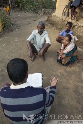 Pastor sharing with a family - Gospel for Asia - KP Yohannan