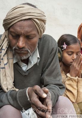 Daughter praying with father