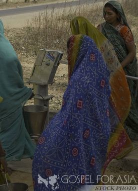Women getting clean water from a Jesus Well