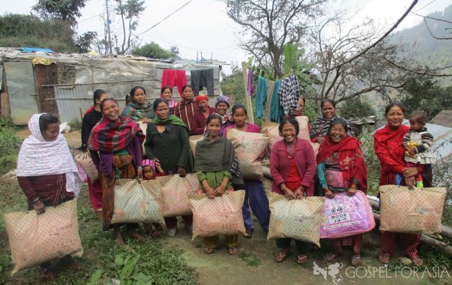 Some of the village ladies are happy to receive winter blankets.
