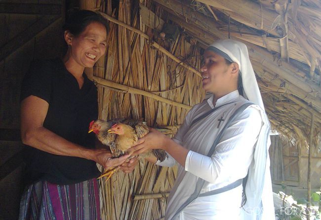 Neha, a widow, received a pair of chickens from the Sisters of Compassion.