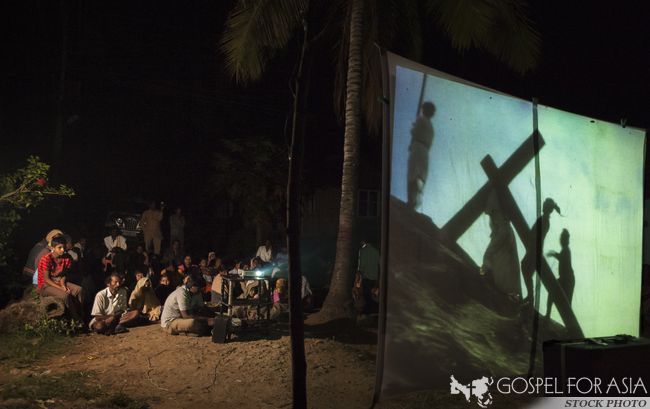 Villagers watch a film on the life of Jesus