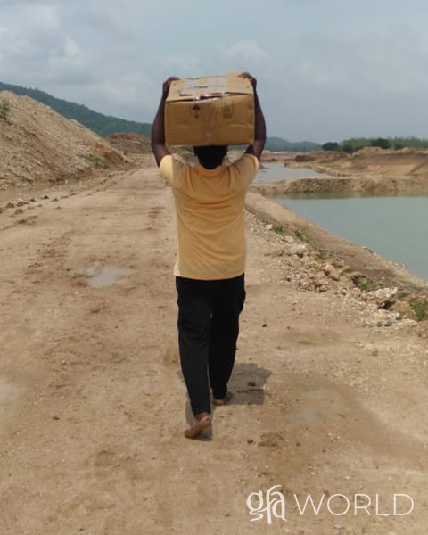 GFA Worker carries supplies for free medical camp.