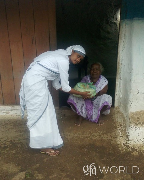 Sister of Compassion gives food and other items to a widow in need.