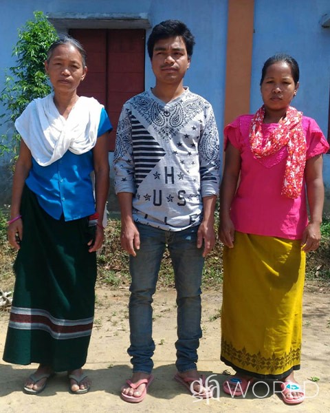 Woman pictured with her son and his wife.