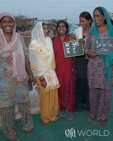 Women happy that they are able to learn to read and write.