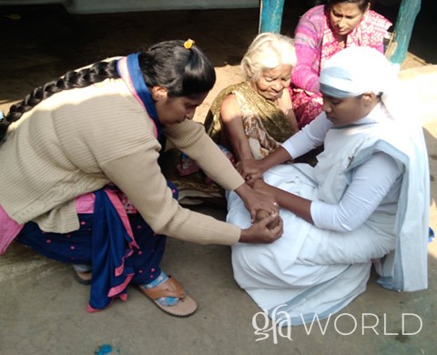 GFA workers taking care of an elderly woman. 