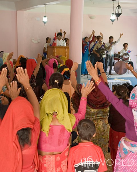 People in a church worshipping.