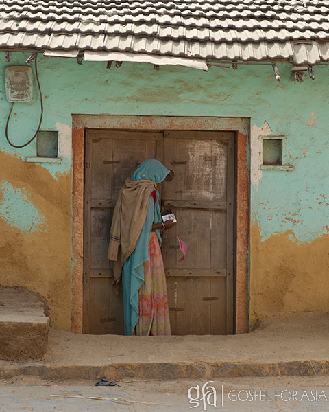 woman reading in front of door