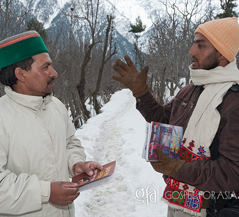 man sharing gospel tracts in the winter