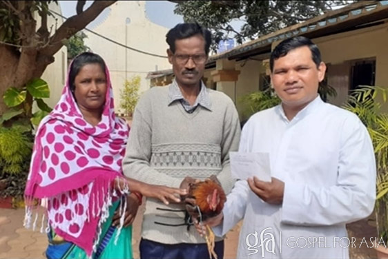 This couple pictured with a chicken like they donated along with funds for the conference.