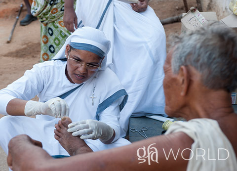 Sister of Compassion giving medical care to a leprosy patient.