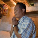 Pastor Bikram Rai , GFA ID 500449, is praying and reading his Bible in his bedroom.